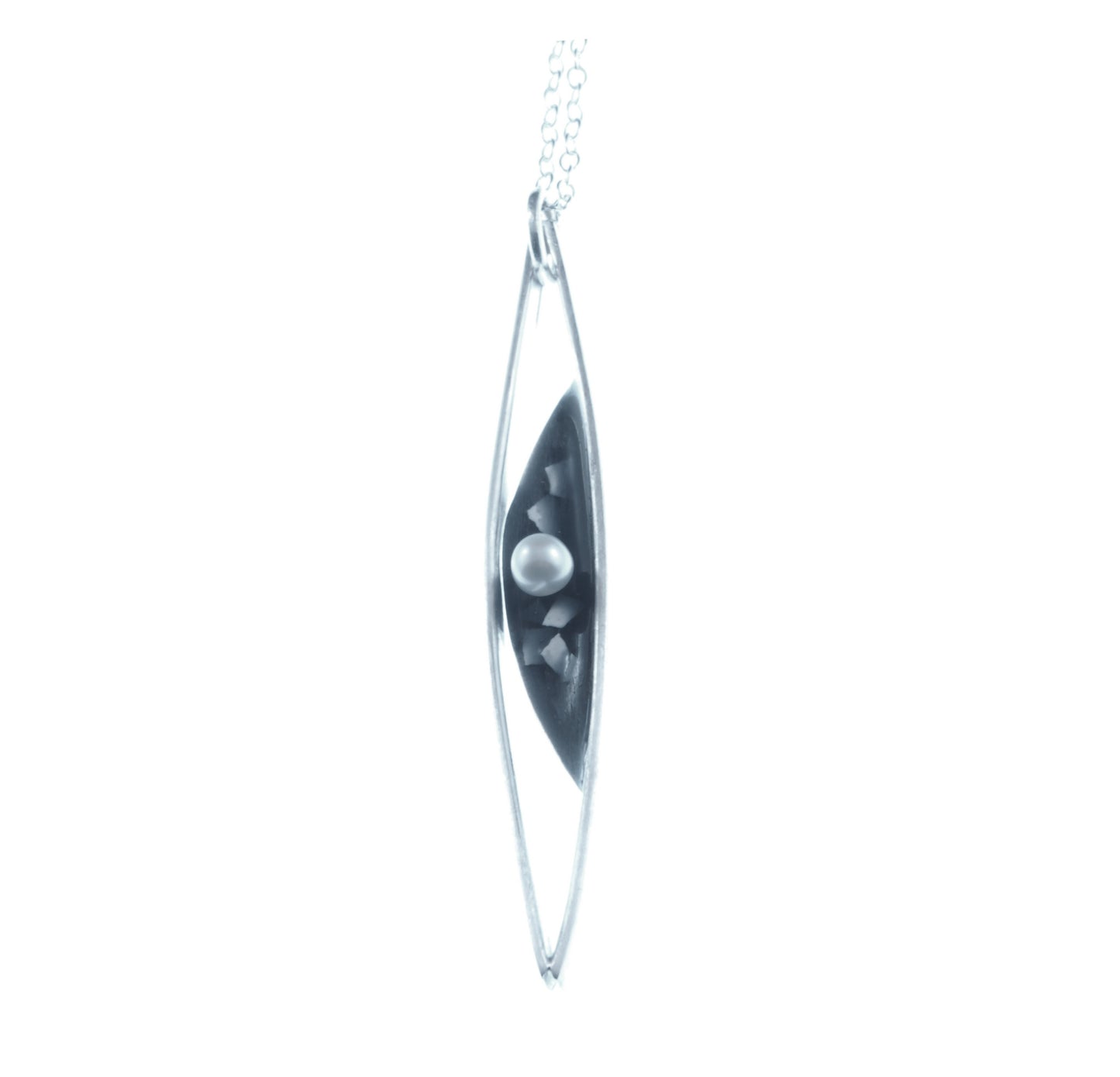 this is a delicate little necklace made from sterling silver, fresh water pearl, resin and crushed egg shell. It is a stylish, sophisticated look and unique in design.