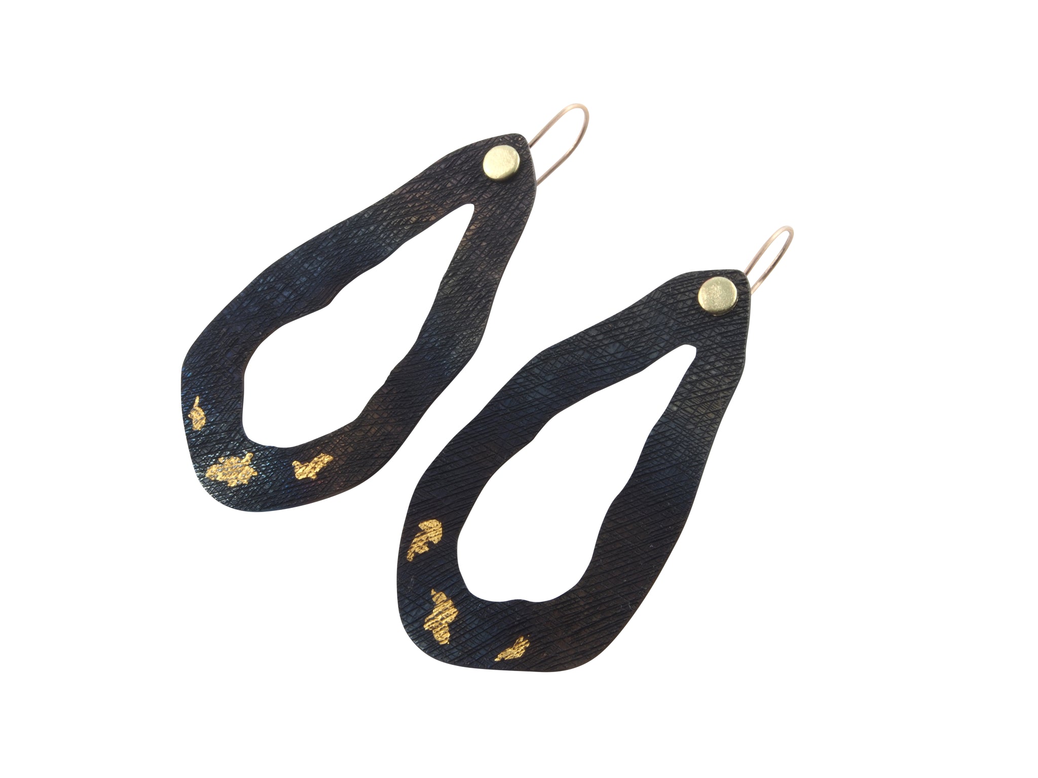 These earrings are part of a series of jewellery pieces about Tasmanian lakes. They are made from hand textured steel, inlaid gold and have 18 ct gold ear-wires.