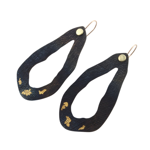 These earrings are part of a series of jewellery pieces about Tasmanian lakes. They are made from hand textured steel, inlaid gold and have 18 ct gold ear-wires.