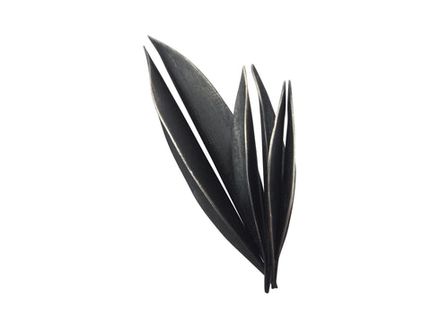 This brooch is hand-forged from sterling silver. The black is a patina applied after the brooch has been completed. It is a large sculptural brooch which really makes a statement.